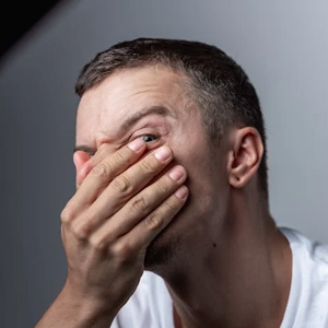 Young man experiencing facial pain