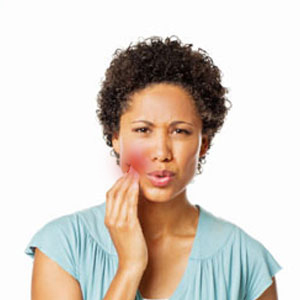 Woman holding a painful cheek