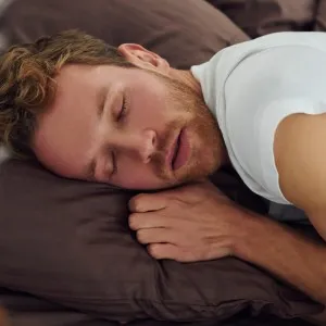 Man sleeping peacefully on a pillow