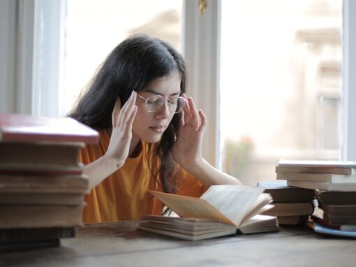 Woman resting her head in her hands with a persistent headache