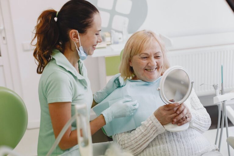 Woman reclined in a dental chair while a clinician examines her