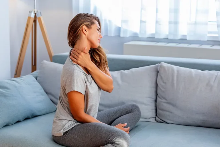 Woman gripping the side of her neck where a muscle has tightened