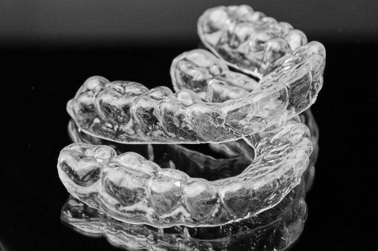 Clear custom-fitted oral appliance resting on a clinical surface